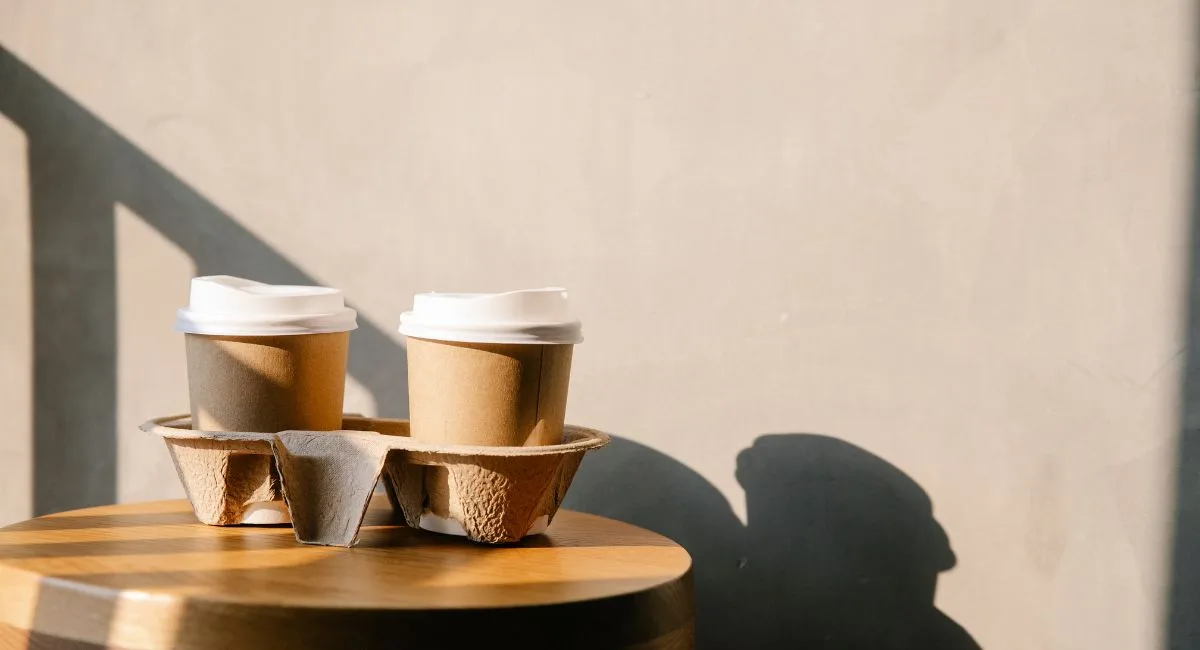 Molded pulp 2-cup carrier holding two kraft coffee cups with white lids — wholesale cup carriers and drink holders from CupsPak
