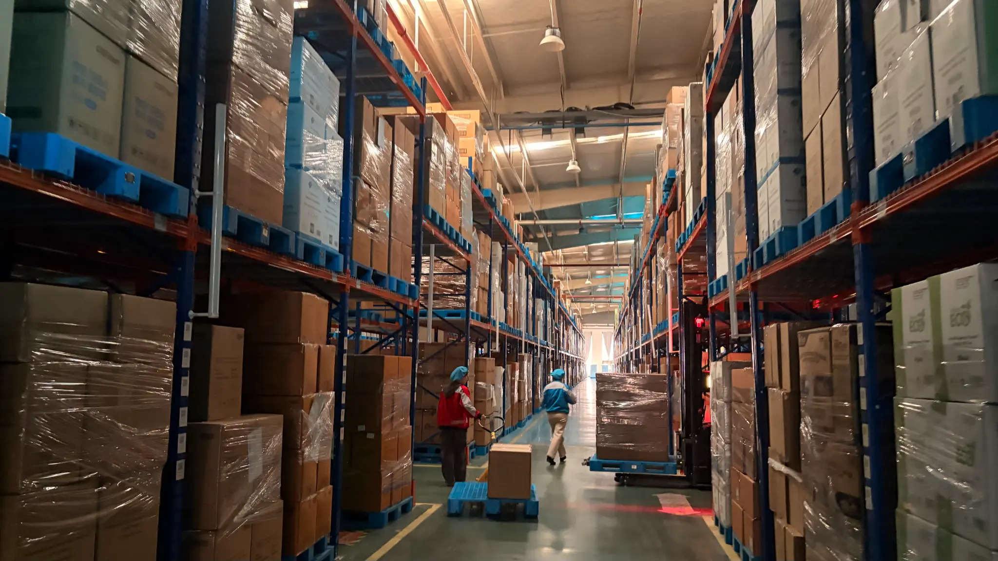 CupsPak warehouse and logistics — workers fulfilling paper cup export orders in a high-density storage facility