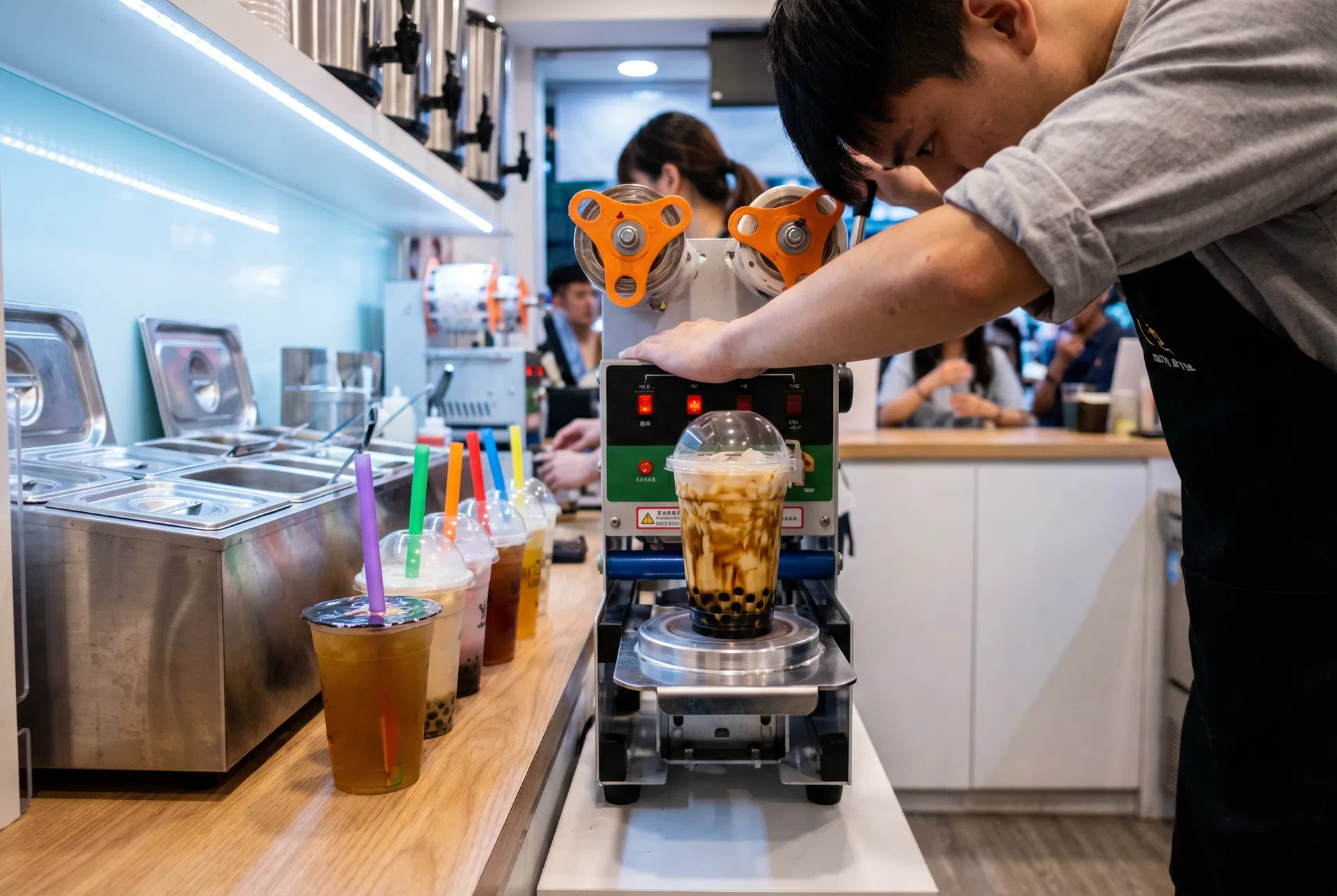 Colourful bubble tea drinks in clear cups with dome lids and wide-bore straws